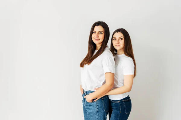 Beautiful two brunette girls in white t-shirts — Stock Photo, Image