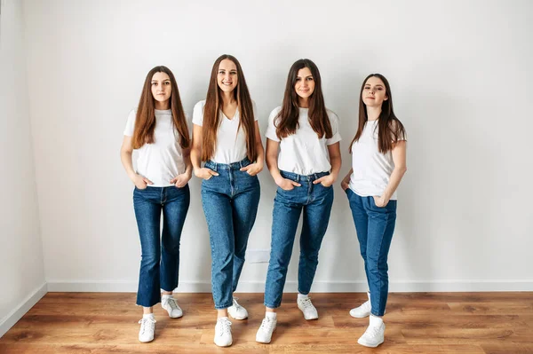 Group of young girls in casual wear in studio — Stock Photo, Image