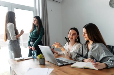 Girl intern writes notes in a notebook
