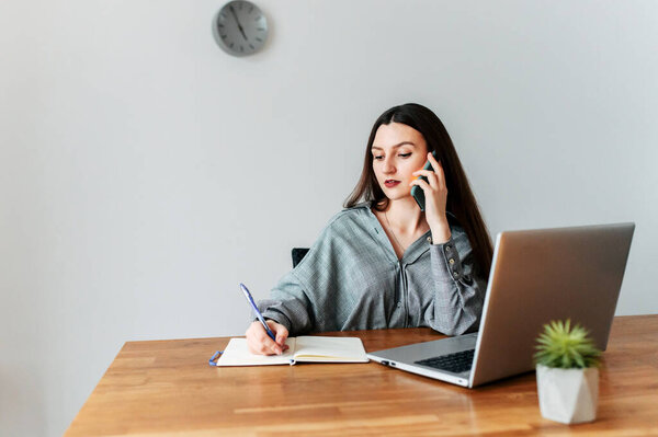 Young attractive woman in smart casual in office