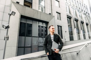 Modern young and creative businessman with laptop