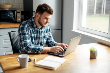 Young male freelancer works from home