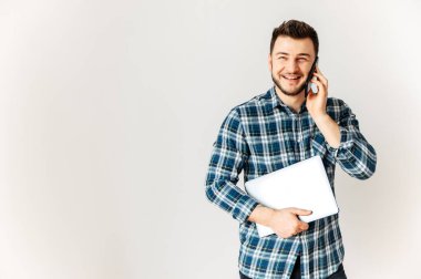 Positive young business man with laptop