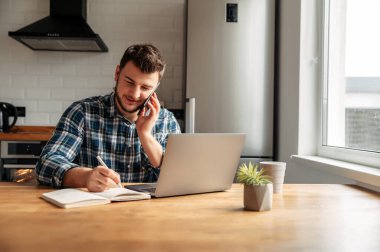 Young male freelancer works from home