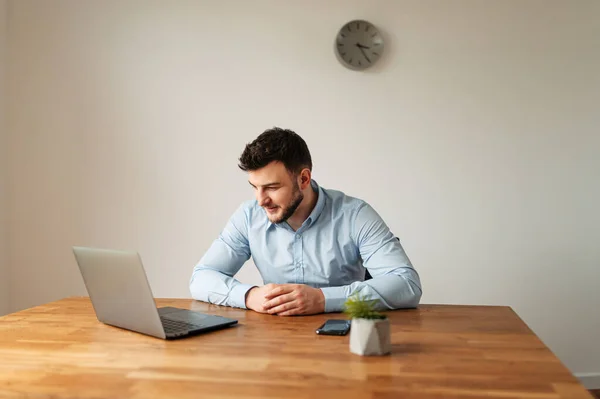Atractivo trabajador de oficina masculino está utilizando una computadora portátil — Foto de Stock