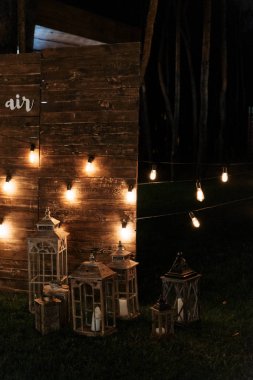Evening wedding ceremony with garlands of lamps