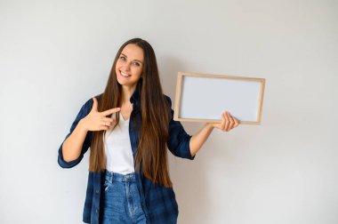 Young girl holding a blank sign in her hands