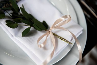 The decor on the plate is a branch of eucalyptus