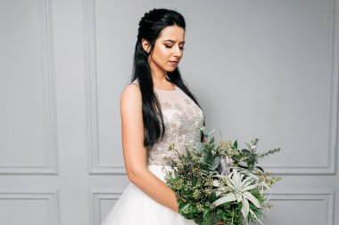 Uzun saçlı ve profesyonel makyajlı bir gelin.