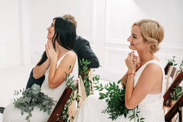 The exited guests look at the newlyweds