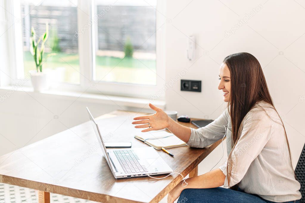 Woman uses laptop for video conference