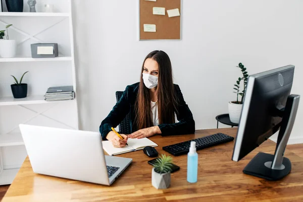 Woman in medical mask at the office