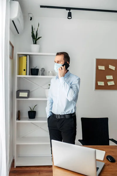 Man in a medical mask at the office