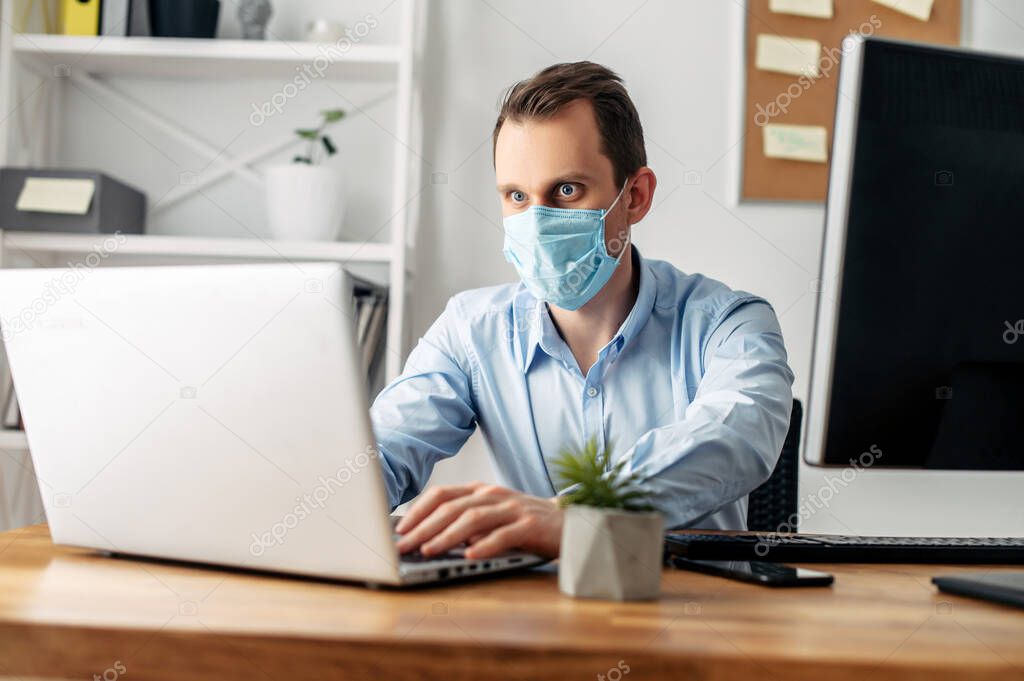 Man in a medical mask at the office