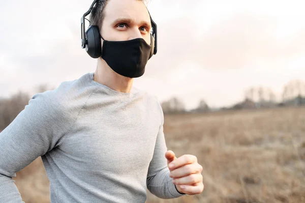 Guy in a medical mask is jogging — Stock Photo, Image