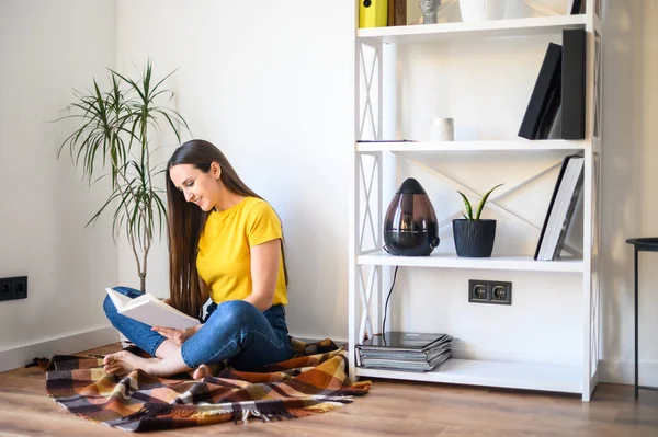 Una joven está leyendo un libro. — Foto de Stock