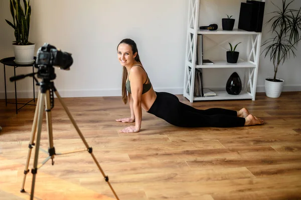 Female yoga coach records video tutorial