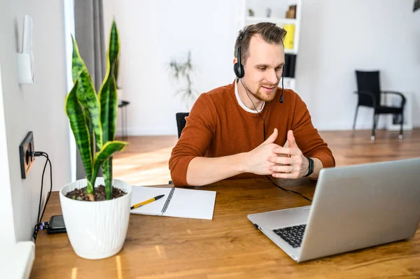 The guy uses hands-free headsets to work from home — Stock Photo, Image