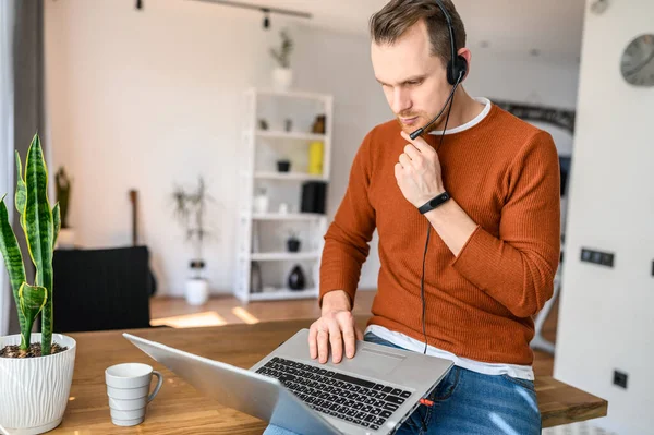 The guy uses hands-free headsets to work from home