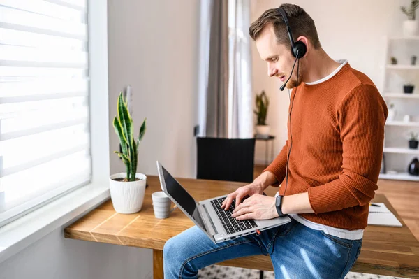 The guy uses hands-free headsets to work from home