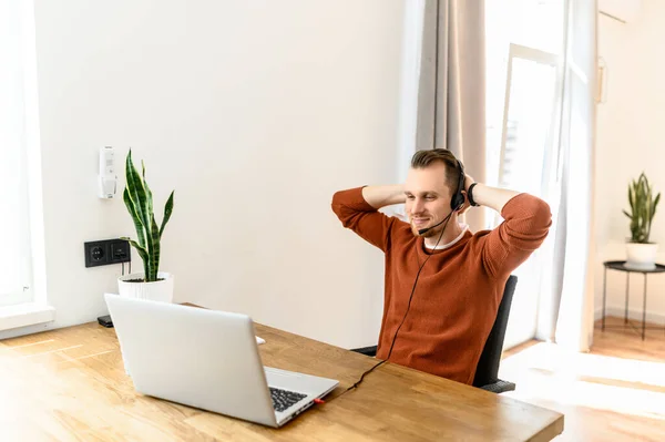 The guy with the headset rests on workplace