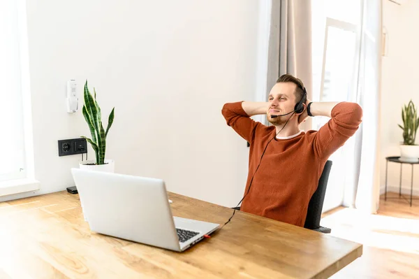 The guy with the headset rests on workplace