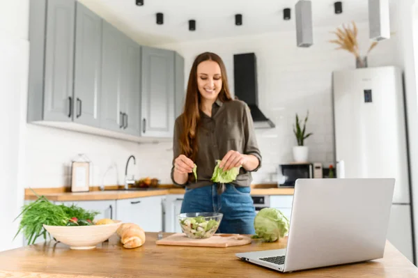 Mulher assistindo cozinhar vídeo na cozinha — Fotografia de Stock