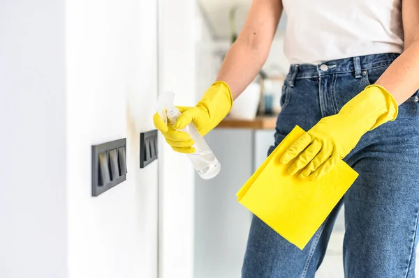Hands in a gloves is cleaning the wall switches — Stock Photo, Image