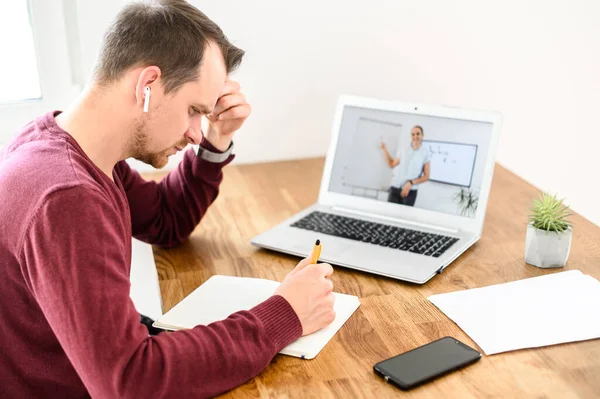 A young guy is studying online, watching webinars — Stock Photo, Image