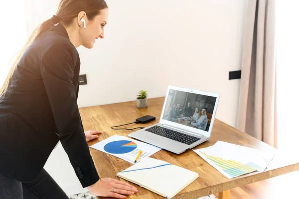 Een jonge vrouw verbindt via video met collega 's — Stockfoto