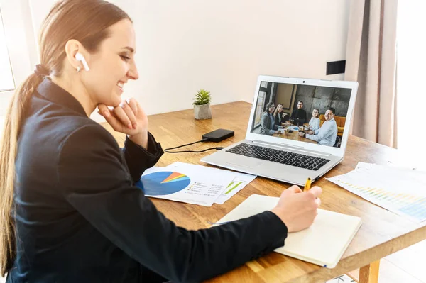 Uma jovem se conecta via vídeo com colegas de trabalho — Fotografia de Stock