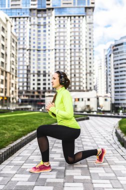 Kadın dışarıda antrenmandan önce ısınıyor.