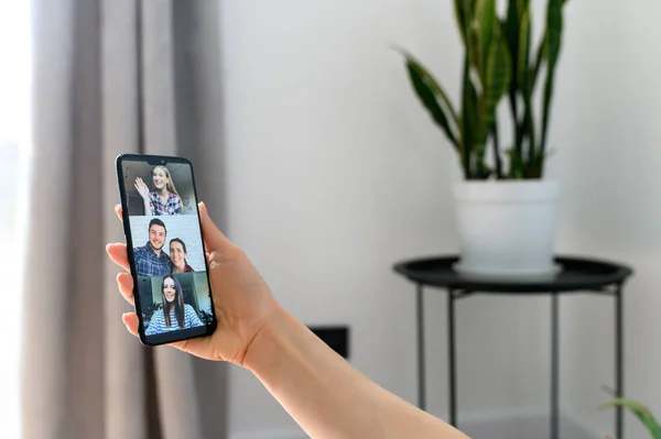 Video meeting on smartphone screen, zoom app