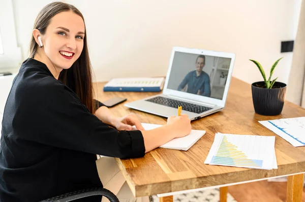 Eine junge Frau schaut Webinar am Laptop — Stockfoto