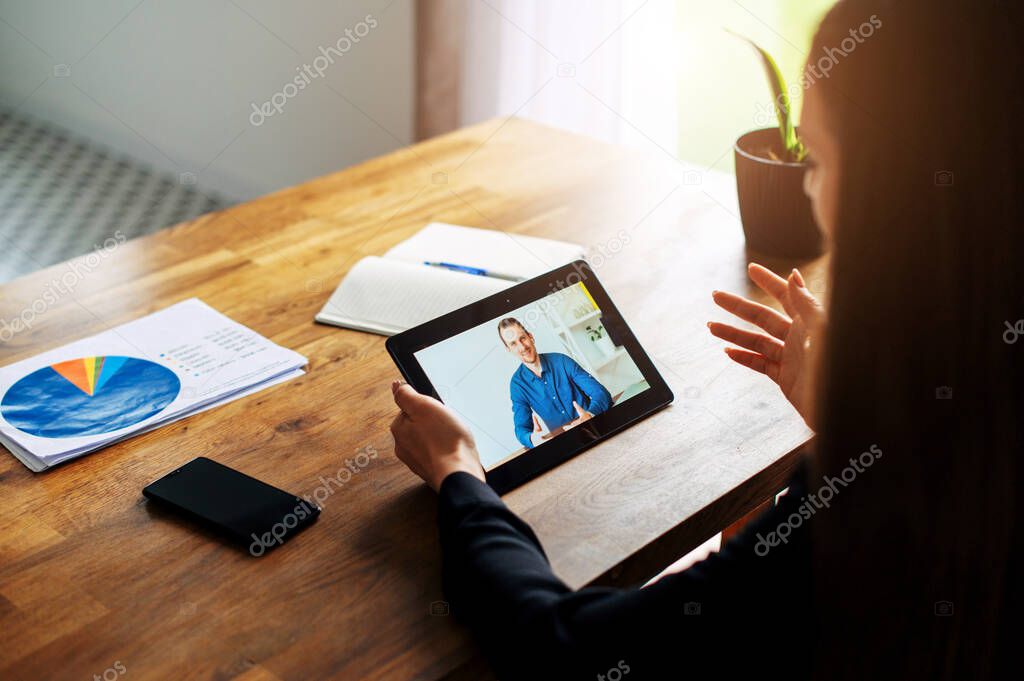 Woman using a tablet for video call in office