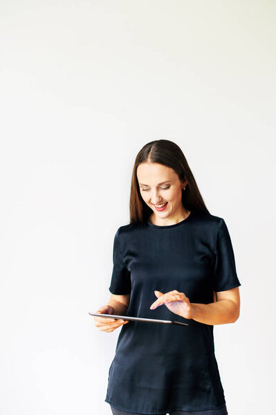 Young woman with a tablet isolated on white