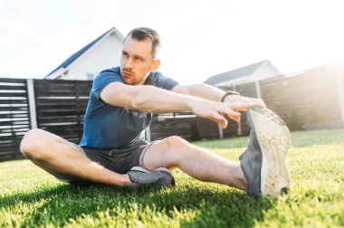 Dışarıdaki antrenmandan önce ısınan bir adam.
