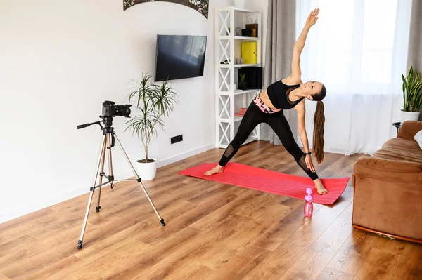 A young woman records sports videos