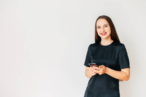 young girl in black t-shirt with a smartphone