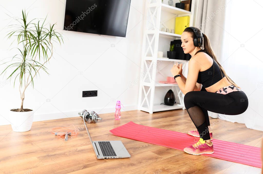 A young woman is training at home