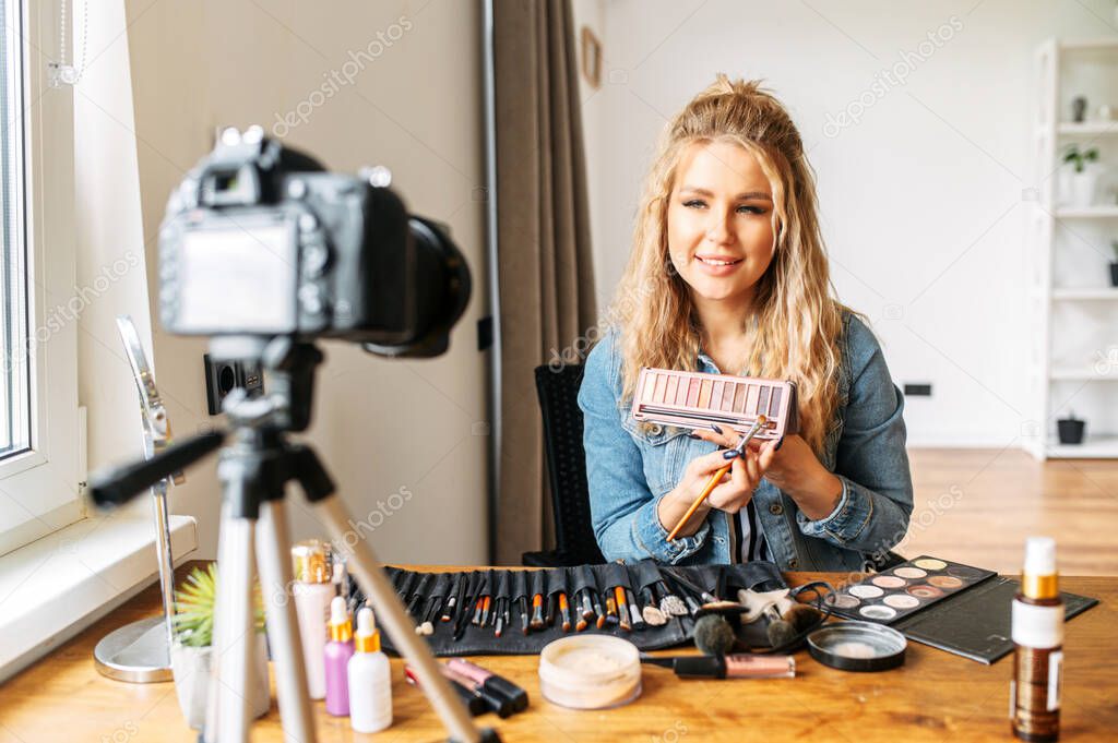 Blonde woman making a video for beauty blog