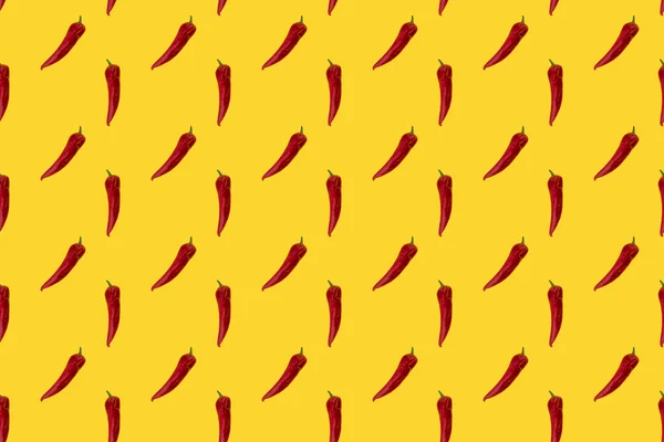 Red pepper on yellow seamless pattern.