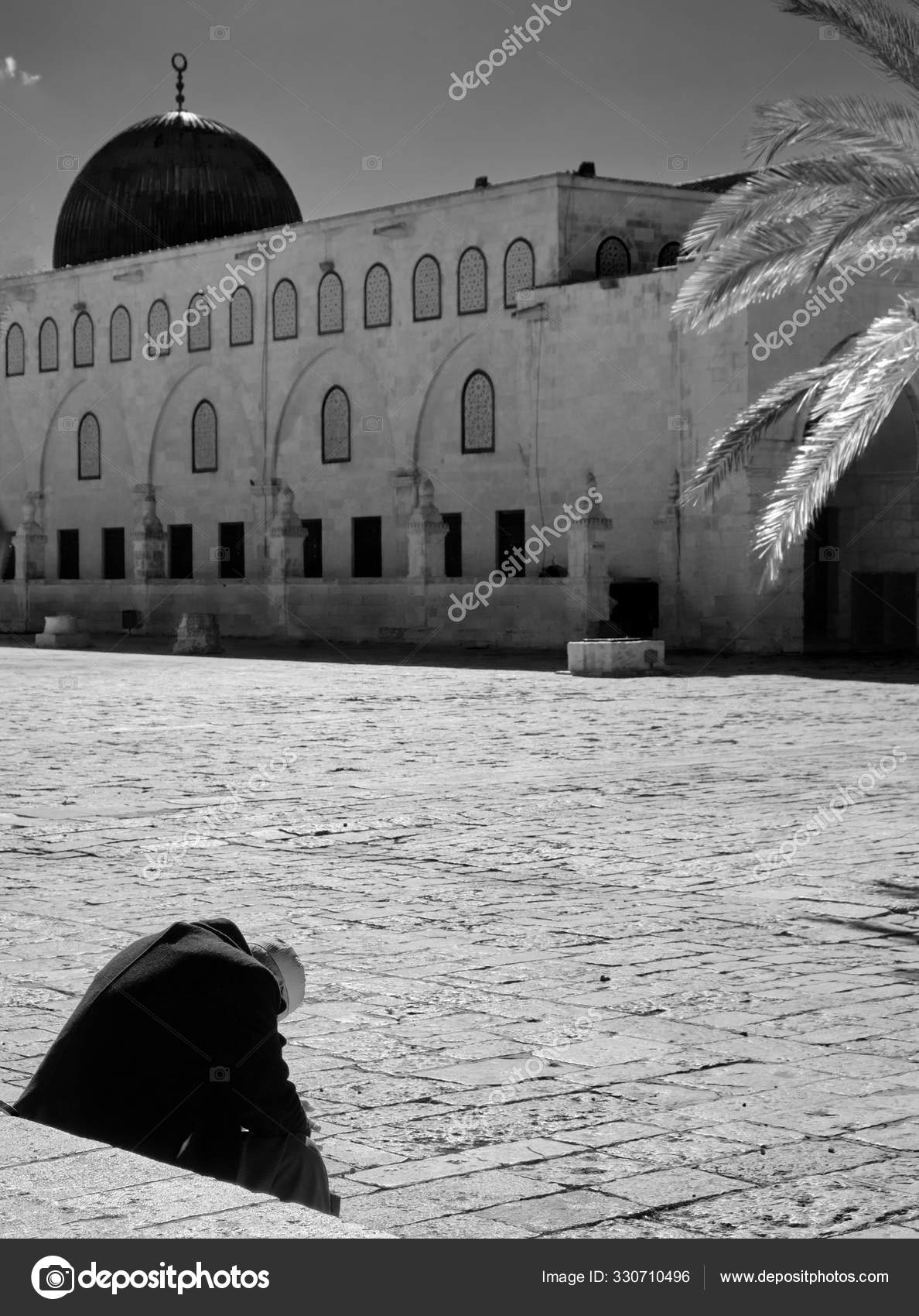 Muslim praying alone in the Dome of the Rock and Dome of the Chain on