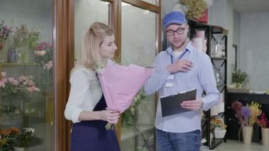 customer care, modern flower shop provides fast and high-quality delivery of bouquets from flower shop, male delivery man will check order list in store, small business success
