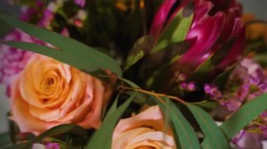 modern design flower bouquet made for delivery or sale of florist shop by professional creative florist rotates on dark background, close-up