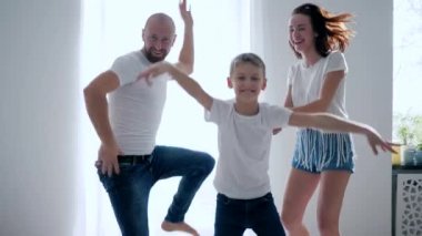 boy with parents is fooling around and jumps on bed in slow motion, funny moments