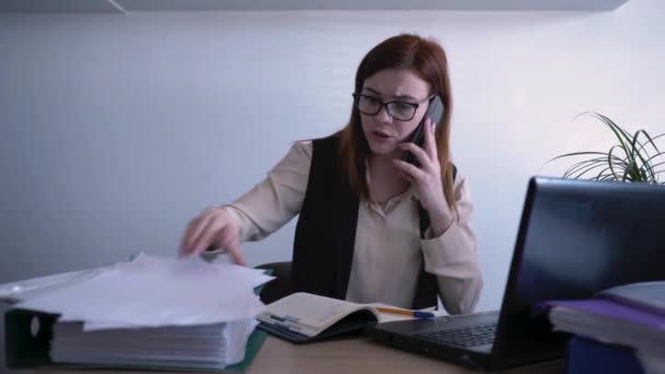 Stress at work, female employee is nervous and screaming out of anger at employee while talking on phone due to poor work, problems at work or failure in business — Stock Video