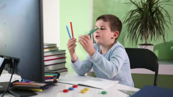 Distance education, cute boy elementary school student learns lessons online with video teacher — Stock Video