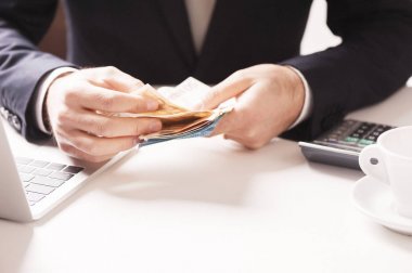 Elinde para tutan adam.