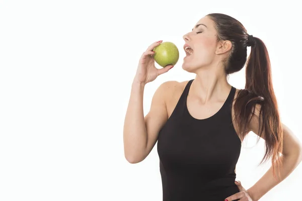 Junge kaukasische Frau mit Apfel im Arm. Fitness und Ernährungskonzept. Gesunder Lebensstil Stockbild